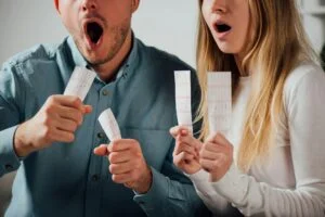 cropped view of shocked man and woman holding lottery tickets