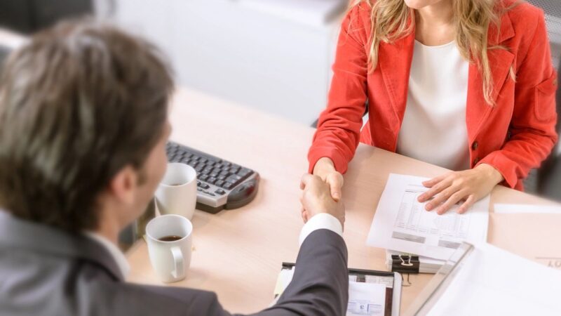 Financial Planning Licenses and Certifications Fnancial Advisor shaking hands with a client